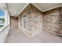 Close up of front porch with stone detail and white railings providing curb appeal at 402 Homestead Dr, Dallas, GA 30157