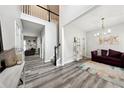 Open-concept living space with new flooring and a view of the home's entry and upper level at 402 Homestead Dr, Dallas, GA 30157