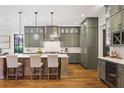 Modern kitchen featuring an island, pendant lighting, custom cabinets, and hardwood floors at 11 Brownson Ct, Acworth, GA 30101