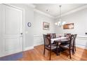 Charming dining area featuring wainscoting, hardwood floors, and an elegant chandelier at 2300 Peachford Rd # 2404, Atlanta, GA 30338