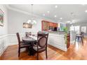 Formal dining room with wainscoting, hardwood floors, and a traditional chandelier at 2300 Peachford Rd # 2404, Atlanta, GA 30338