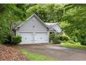 Charming home with two-car garage, mature trees, and well-maintained landscaping at 245 London Ln, Hiram, GA 30141