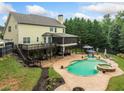 Stunning backyard featuring a private pool, spa, multi-level deck, and outdoor entertaining space at 360 Glade Knoll Trail Trl, Fayetteville, GA 30215
