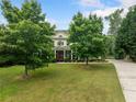 Beautiful home nestled on a well-manicured lot, showcasing curb appeal and lush greenery at 360 Glade Knoll Trail Trl, Fayetteville, GA 30215