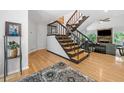 Bright foyer with hardwood floors, staircase, and seamless access to the living room at 545 Matterhorn Way Way, Alpharetta, GA 30022