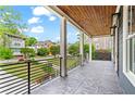 Spacious front porch with beautiful tile flooring, columns and a black metal railing at 2493 Oostanaula Ne Dr, Brookhaven, GA 30319