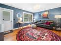 Stylish living room with hardwood floors, a leather couch, and a decorative round rug at 3190 Crestview Circle Nw Cir, Duluth, GA 30096