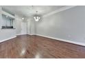 Empty dining room with wood floors, decorative light fixture, and pass-through to the kitchen at 3334 Peachtree Ne Rd # 614, Atlanta, GA 30326