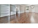 A light and airy living room featuring gleaming wood floors and built-in shelving with a desk at 3334 Peachtree Ne Rd # 614, Atlanta, GA 30326