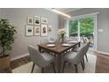 Stylish dining area with a modern light fixture and access to a wooden deck at 5147 Manerdale Se Dr # 5, Vinings, GA 30339