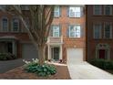 Charming townhome with brick facade, private garages, and welcoming curb appeal at 5147 Manerdale Se Dr # 5, Vinings, GA 30339