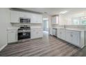 Bright kitchen features modern appliances, white cabinets, and quartz countertops at 621 Lakewater View Dr, Stone Mountain, GA 30087