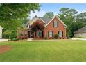 Charming brick two-story home with manicured lawn and landscape at 1012 Chestnut Creek Dr, Villa Rica, GA 30180