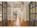 Elegant foyer with hardwood floors, staircase, and open view to the second level at 10565 Highgate Manor Ct, Duluth, GA 30097