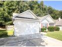This home has a one car garage with an extended driveway and manicured lawn at 159 Misty Ridge Trl, Stockbridge, GA 30281