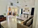Open-concept living room with fireplace, hardwood flooring and adjacent kitchen area at 159 Misty Ridge Trl, Stockbridge, GA 30281