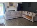 Spacious living room with a cozy sectional sofa, fireplace, and hardwood flooring at 159 Misty Ridge Trl, Stockbridge, GA 30281