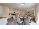 Open-concept kitchen and dining area featuring granite counters, stainless steel appliances, and hardwood floors at 337 Torcello Blvd, Mcdonough, GA 30253