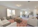 Bright and airy living room featuring an open floor plan, neutral colors, and a large window at 337 Torcello Blvd, Mcdonough, GA 30253