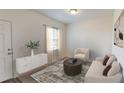 Cozy living room featuring natural light and neutral colors, with a door to the outside at 337 Torcello Blvd, Mcdonough, GA 30253