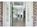 Elegant foyer with hardwood floors, decorative staircase, and open view to other living spaces at 6105 Overlook Park Dr, Cumming, GA 30040