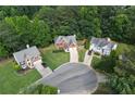 An aerial view shows the property nestled in a cul-de-sac surrounded by lush greenery at 206 Five Iron Nw Ct, Kennesaw, GA 30144