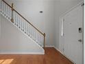 Bright entryway featuring hardwood floors, a staircase, and a white front door at 206 Five Iron Nw Ct, Kennesaw, GA 30144