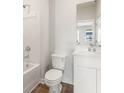 Well-lit bathroom showcasing a tub with shower, toilet, and vanity with white cabinets at 4036 Trimrose Ct, Atlanta, GA 30349