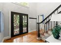Charming foyer featuring wood floors, a decorative door, and a staircase at 4246 N Mountain Ne Rd, Marietta, GA 30066