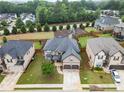 An aerial view showing a charming home nestled between neighboring houses with a playground in the community at 212 Jetta Cir, Mcdonough, GA 30253