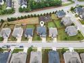 An aerial view displays a beautiful home in a suburban community with a neighborhood park at 212 Jetta Cir, Mcdonough, GA 30253