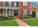 Close up of the front exterior of the home showing the brick walkway and landscaped front yard at 952 Moores Walk Ln, Suwanee, GA 30024