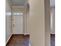 Bright foyer featuring hardwood floors, arched doorways, and a white front door at 2280 Copper Trail Ln, Buford, GA 30519