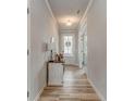 Bright entryway with wood floors, stylish console table, and a view of the front door with wreath at 28 Rolling Rock Way, Dallas, GA 30157