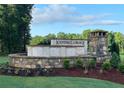 Kendall Grove community entrance featuring stone and brick design with lush landscaping at 329 Torcello Blvd, Mcdonough, GA 30253