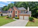 Beautiful two-story brick house with a two-car garage and landscaped yard at 3652 Morning Creek Ct, Suwanee, GA 30024