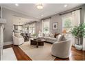 Bright living room featuring hardwood floors, neutral walls, fireplace, large windows, and open to the eat-in kitchen at 583 Etowah Ne Dr, Marietta, GA 30060