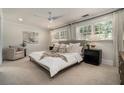 Bright main bedroom featuring carpet, large windows, ceiling fan, and neutral walls create a serene retreat at 583 Etowah Ne Dr, Marietta, GA 30060