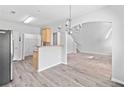 Bright dining area featuring wood floors, modern chandelier, and open access to living room and kitchen at 181 Ridgemont Rd, Canton, GA 30114