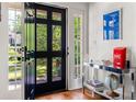 Bright foyer with a decorative console table, hardwood floors, and a glass-paneled front door at 204 Rumson Ne Rd, Atlanta, GA 30305