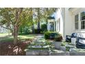 Beautifully landscaped front yard with a stone pathway leading to a cozy seating area at 204 Rumson Ne Rd, Atlanta, GA 30305