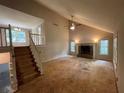 Bright living room featuring a fireplace, vaulted ceilings, and large windows at 3840 Whitaker Ln, Lithia Springs, GA 30122