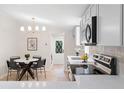 Bright renovated kitchen featuring stainless appliances, modern lighting, and white cabinets at 1010 Martin Ln, Canton, GA 30114