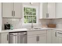 Kitchen features stainless steel dishwasher and sink with window view to exterior at 160 Pine Grove Dr, Canton, GA 30114