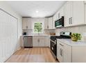 Modern kitchen with stainless steel appliances, white cabinets, and ample countertop space at 160 Pine Grove Dr, Canton, GA 30114