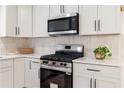 Modern kitchen features a stainless steel range and microwave at 160 Pine Grove Dr, Canton, GA 30114