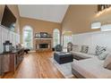 Bright living room featuring a stone fireplace, hardwood floors, and large windows at 3130 Kates Nw Way, Kennesaw, GA 30152