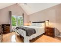 Serene bedroom with vaulted ceilings, large window, and hardwood floors at 114 Emily Ln, Alpharetta, GA 30009