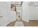 Bright open foyer with wood floors, staircase and white wainscoting welcomes you into the home at 303 Ridgewood Trl, Canton, GA 30115