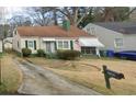 Traditional home with a cozy front porch, quaint green accents, and a neatly kept yard with a mailbox at 1785 S Olympian Sw Way, Atlanta, GA 30310